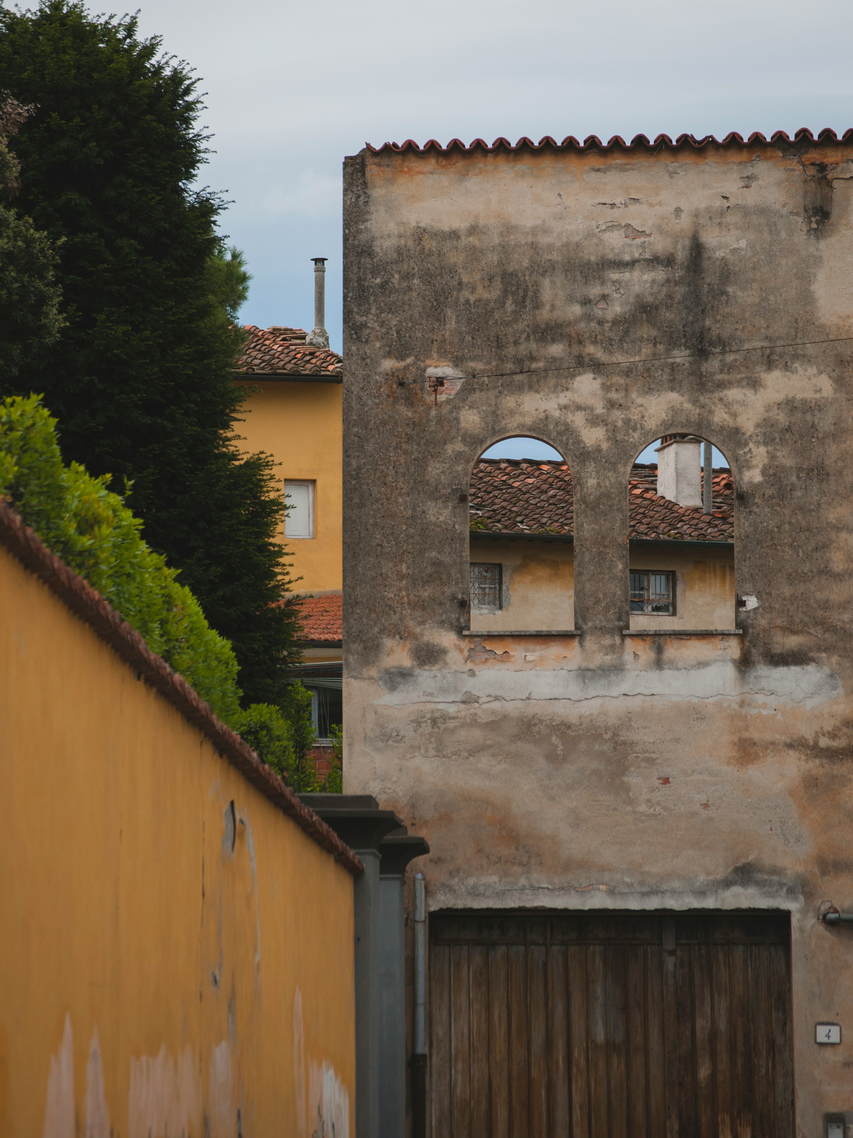 brown concrete building near green trees during daytime